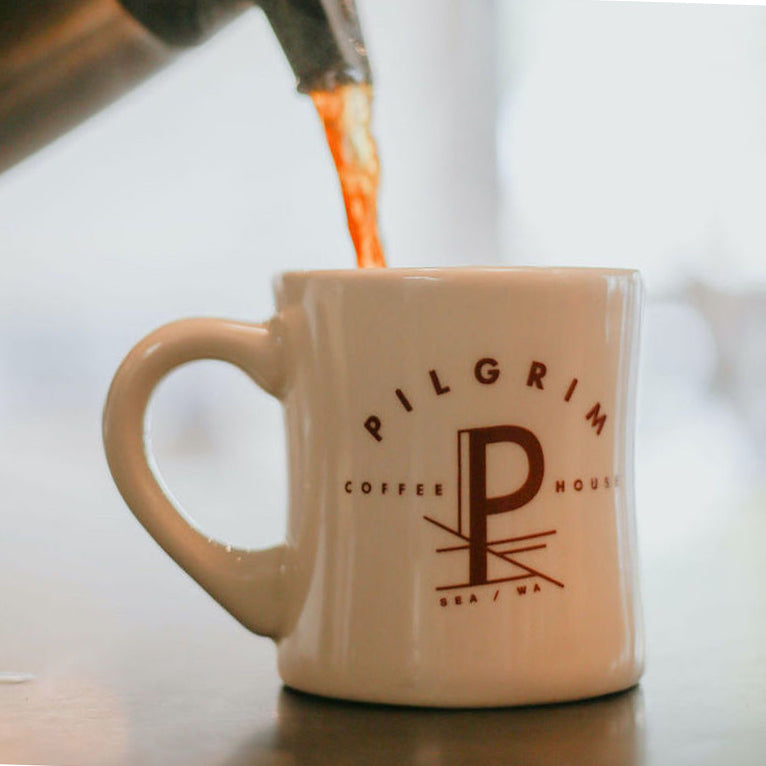 pouring coffee into a pilgrim coffeehouse mug